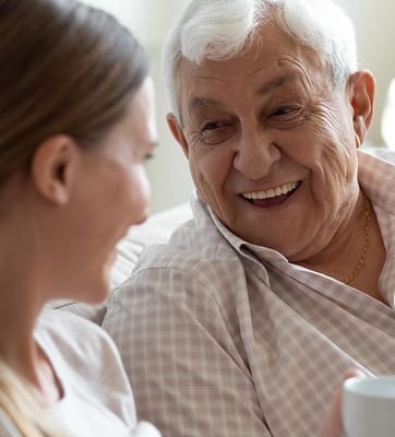 Senior resident enjoying a conversation with a caregiver