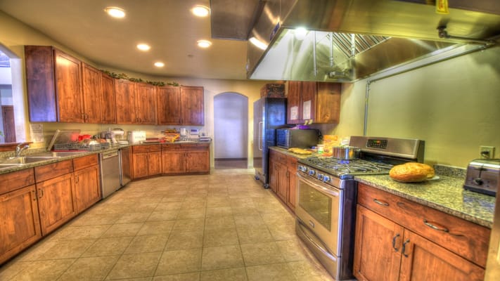 Bright kitchen space with granite countertops and wooden cabinets