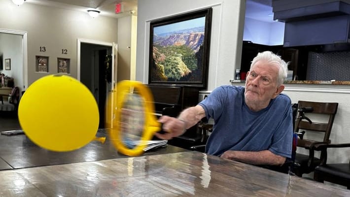 Resident participating in a recreational activity indoors