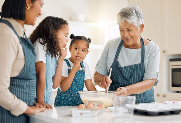 Seniors baking with children in a kitchen