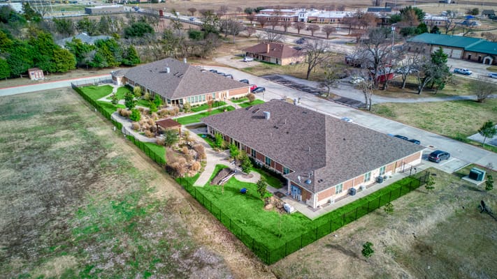 Aerial view of a senior living facility with landscaped gardens