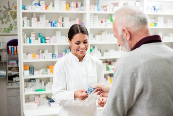 Pharmacist assisting a senior with medications