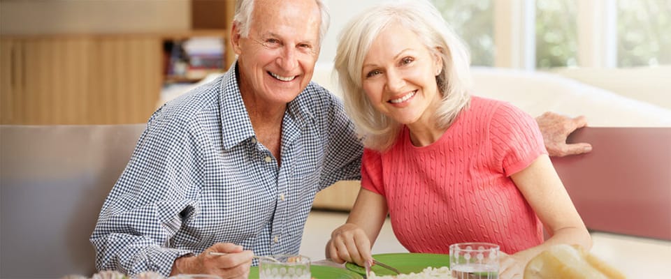 Two seniors enjoying a meal together
