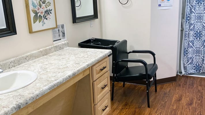 A clean interior space with a sink and chairs
