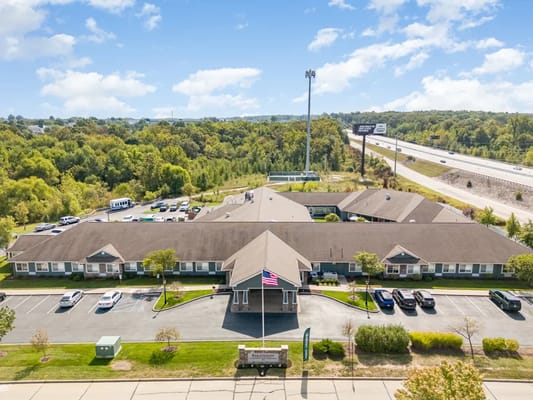 Aerial view of a senior care facility building and parking area