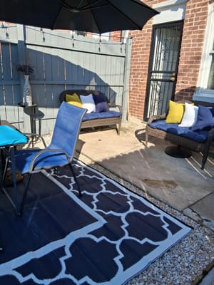 Outdoor seating area with chairs and cushions