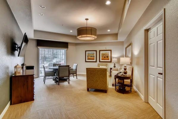 Cozy common area featuring seating and a dining table.