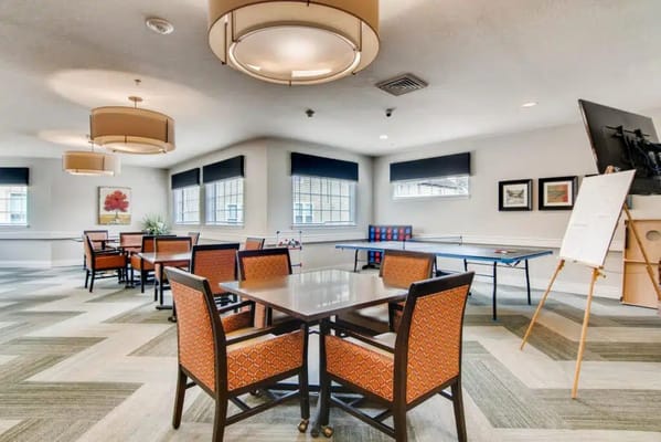 Bright community common area with tables and chairs
