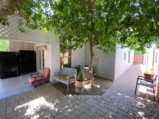 Patio area with seating and landscaping at Orange Garden Assisted Living