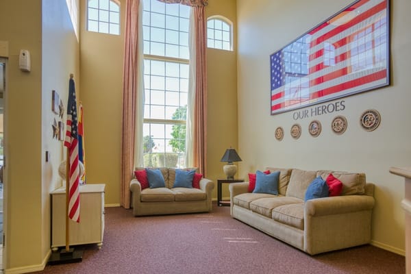 Bright common area with seating and flag display