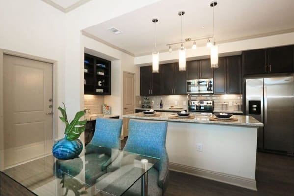 Modern kitchen area with dining table and chairs