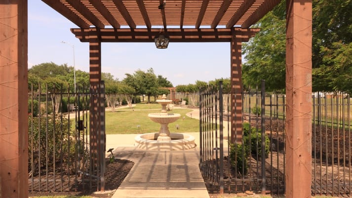 View of a landscaped garden with a fountain and pathway