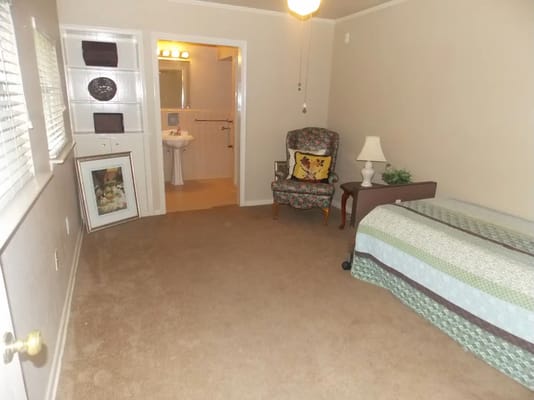 Cozy private resident room with a chair and lamp