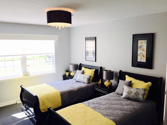 A cozy resident room with twin beds and decor