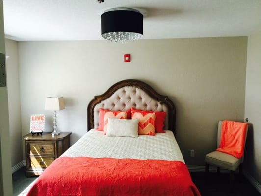 Cozy bedroom with bright bedding in the facility