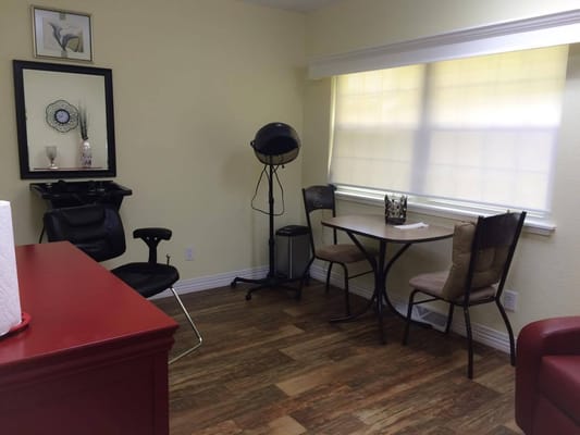 Interior view of a salon area with chairs and mirror