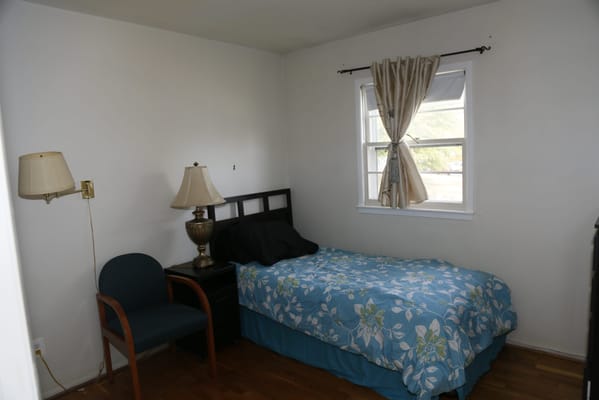 Simple resident room with a bed and chair