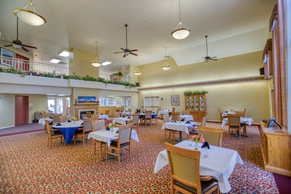 Bright dining room with tables set for meals
