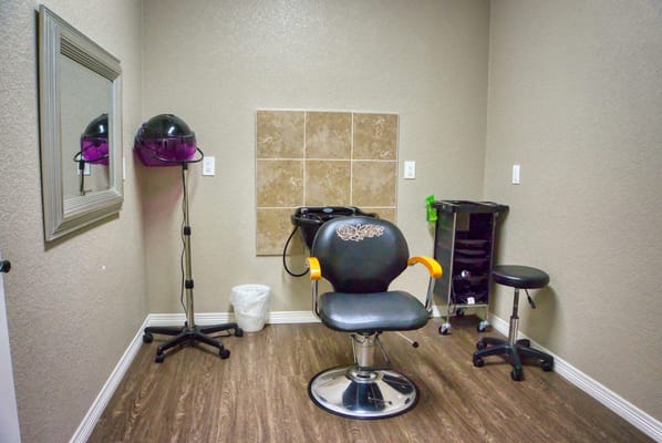 Hair salon area with styling chair and equipment