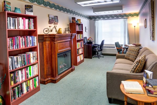 Cozy lounge area with bookshelves and furniture