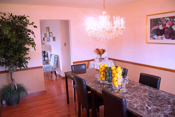 Bright dining area with a chandelier and table setting