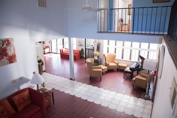 Bright common area with seating and a piano