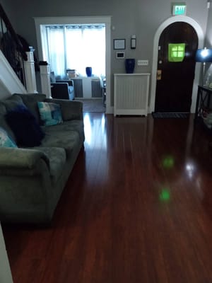 Cozy common area with a couch and wooden flooring