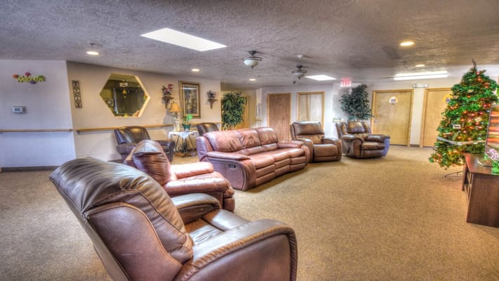 Common area with reclining chairs and holiday decorations