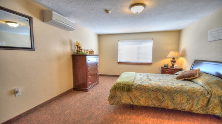 Private resident room with a bed and dresser