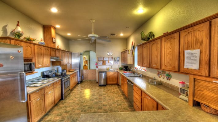 Bright kitchen with wooden cabinets and appliances