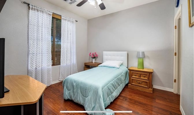 Cozy private bedroom with light blue bedding