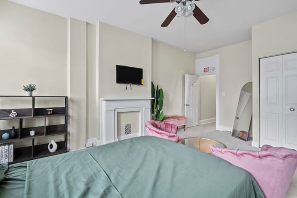 Brightly decorated resident room with a bed and seating area