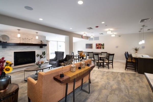 Bright and welcoming lounge area with seating and a fireplace