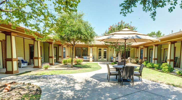 Shaded outdoor seating area in a landscaped courtyard
