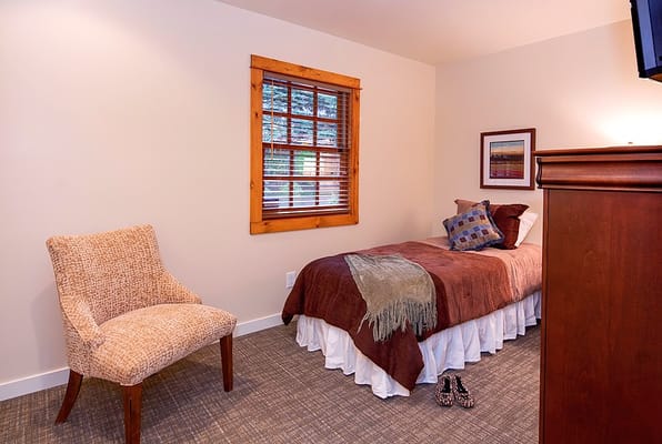 Comfortable private room with a bed and chair