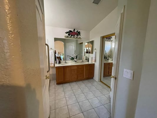 Well-appointed bathroom with dual sinks and decorative plants