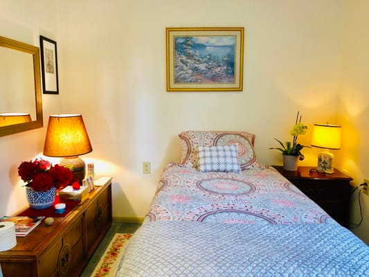 Cozy resident room with bed and lamps