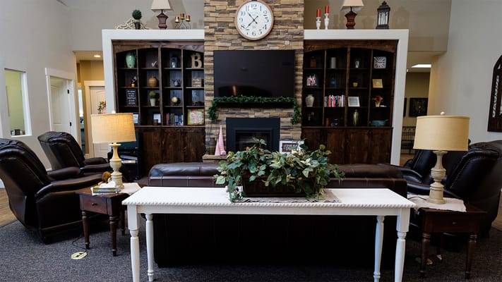 Common area with seating and decor in a senior living facility