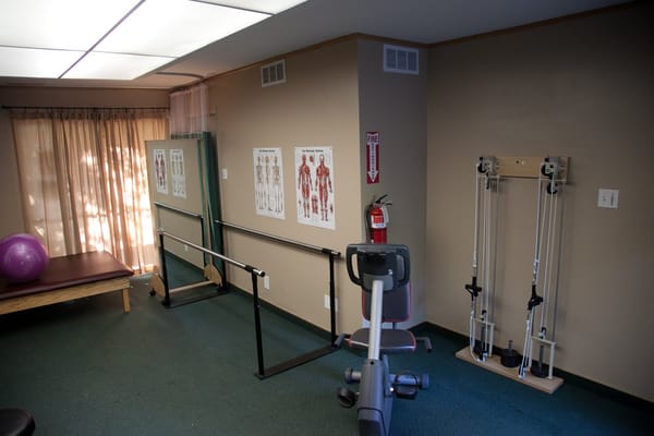 Exercise room featuring equipment and exercise charts