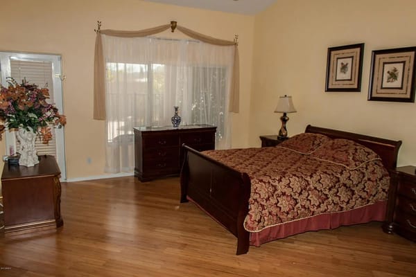 Well-furnished private room with a bed and dresser