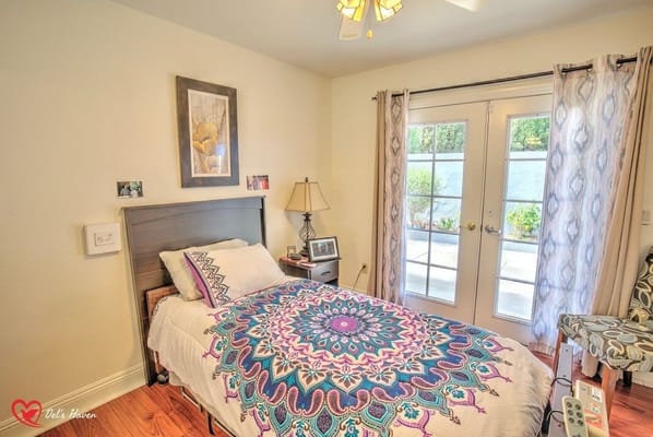 Cozy bedroom featuring a patterned bedspread and French doors