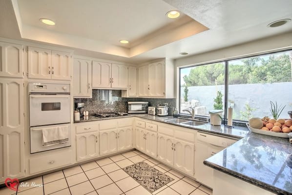 Modern kitchen with white cabinets and granite countertops