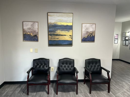 Seating area in a facility lobby with decorative artwork