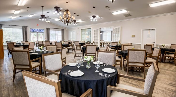 Dining area with tables and chairs set for meals