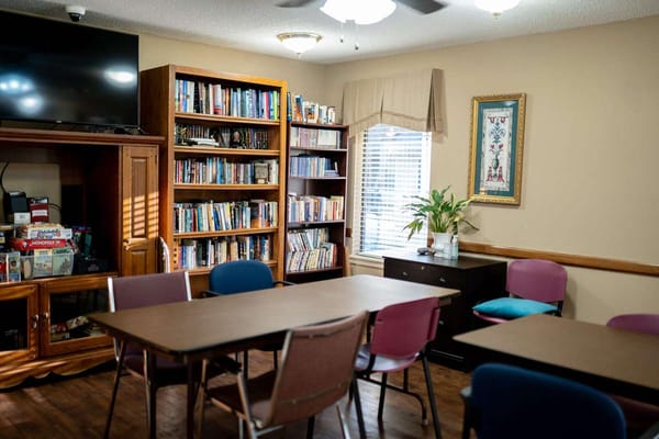 Interior of a common area with bookshelves and tables