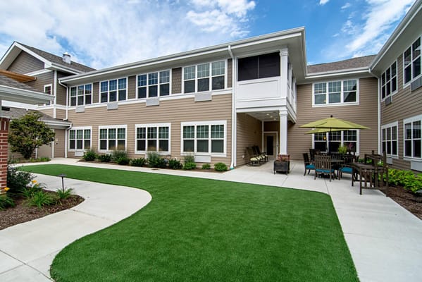 Outdoor courtyard with seating and landscaping at Emerald Place