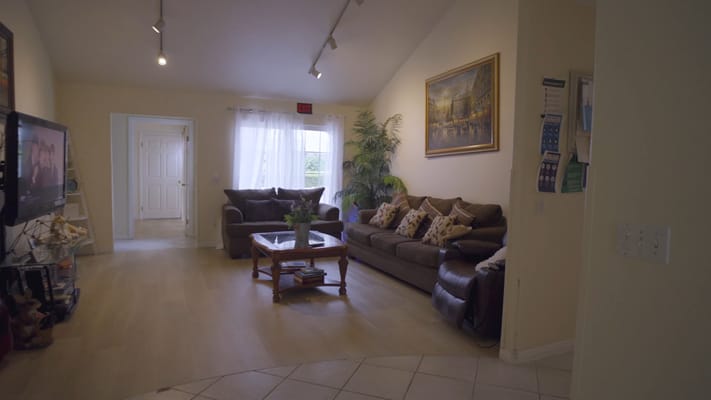 Cozy living room with two sofas, a coffee table, and natural light.
