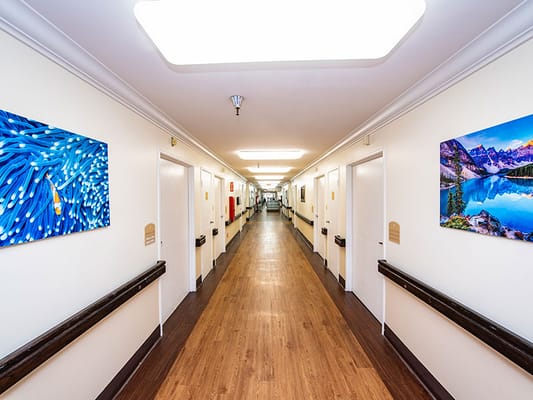 Brightly-lit hallway with artwork on the walls