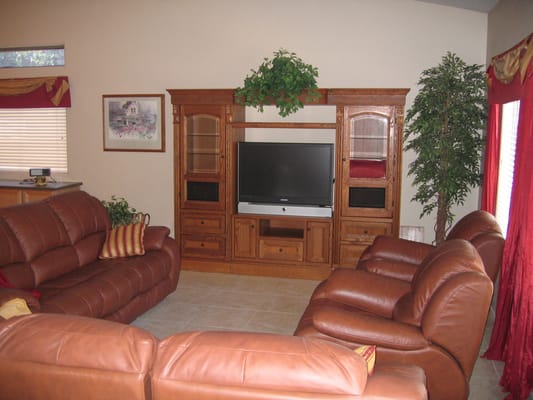 Cozy living room with leather sofas and a TV