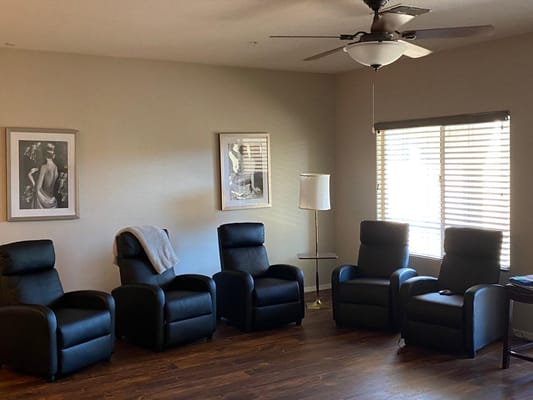 Cozy lounge area with reclining chairs and artwork